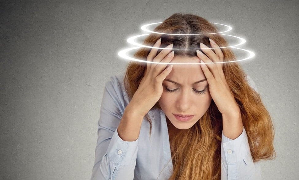 Woman with dizziness and head pain - chiropractor San Antonio TX