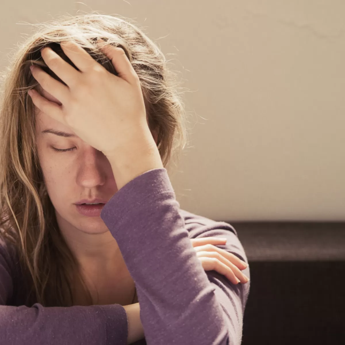 Woman with stress and anxiety tension holding aching head - chiropractor San Antonio TX